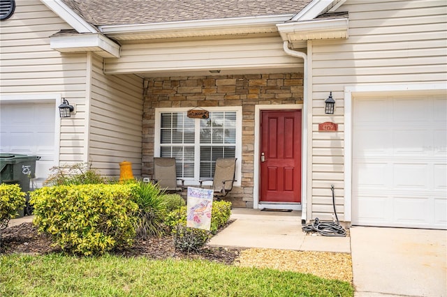 view of exterior entry with a garage