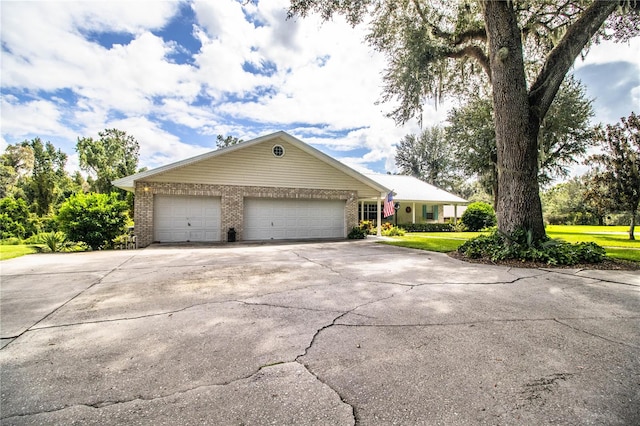 view of front of home with a garage and a front lawn