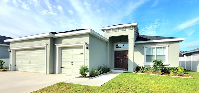 view of front of house featuring a front yard and a garage