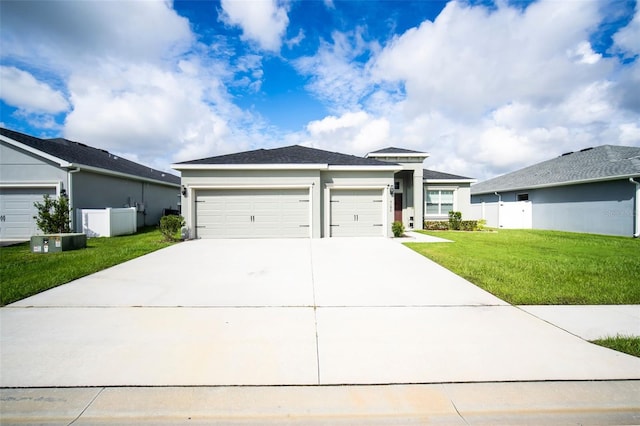 view of front of property with a front yard and a garage