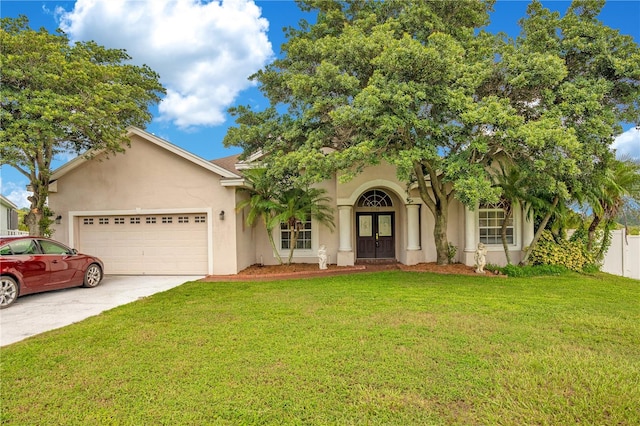 view of front of property featuring a front lawn and a garage