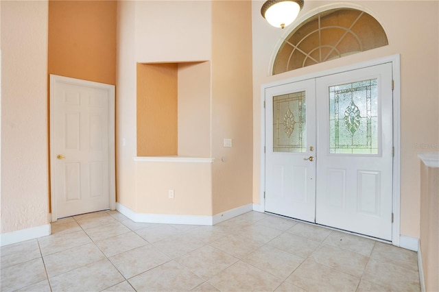 tiled entryway featuring a high ceiling