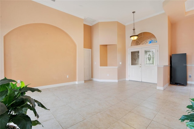 interior space with crown molding, light tile patterned floors, and french doors