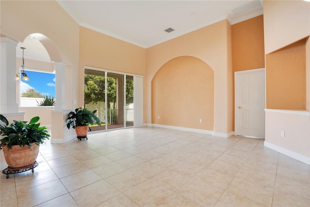 unfurnished room with ornamental molding and light tile patterned floors