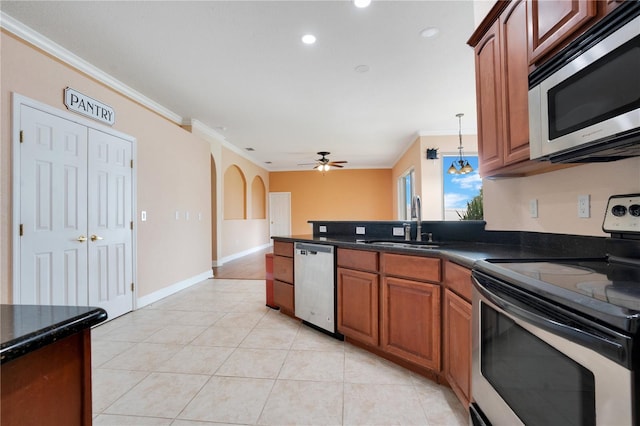 kitchen featuring pendant lighting, light tile patterned floors, stainless steel appliances, sink, and ceiling fan