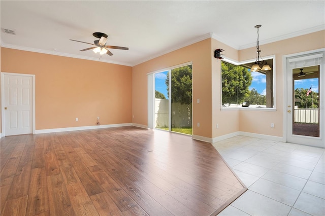 unfurnished room with ceiling fan with notable chandelier, crown molding, and light hardwood / wood-style flooring