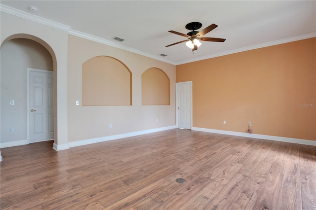 empty room with hardwood / wood-style floors, ceiling fan, and crown molding