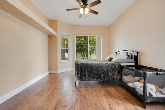 bedroom with ceiling fan and wood-type flooring