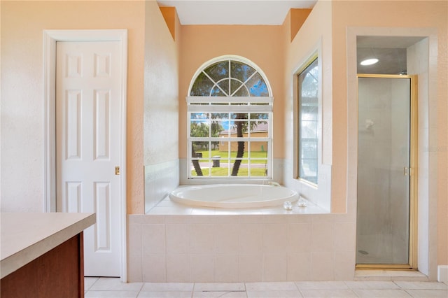 bathroom with vanity, tile patterned floors, and shower with separate bathtub