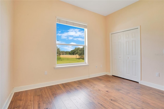 unfurnished bedroom with a closet and wood-type flooring