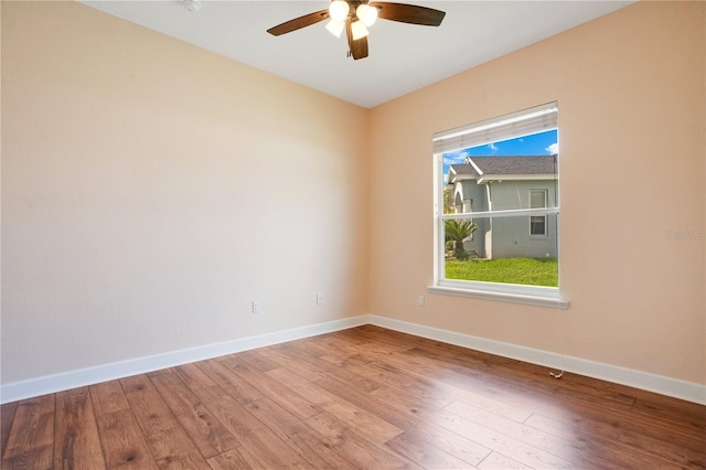 unfurnished room with ceiling fan and hardwood / wood-style flooring