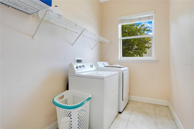 laundry room with light tile patterned floors and washing machine and dryer