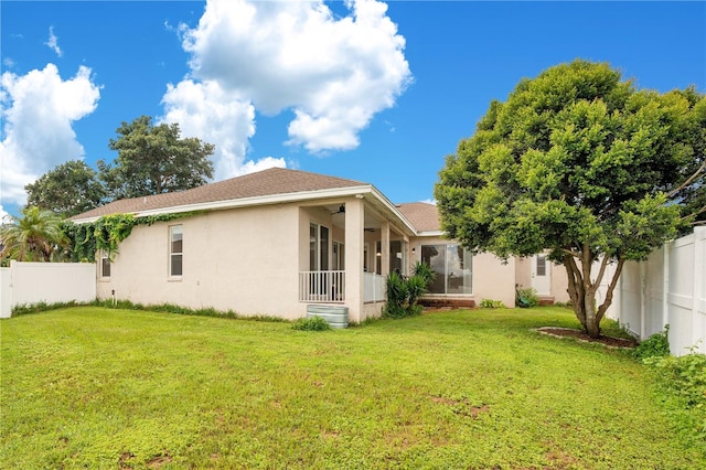 rear view of house with a lawn