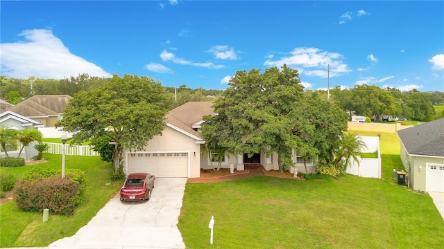 view of front of home with a front lawn and a garage