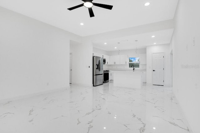 unfurnished living room with sink and ceiling fan