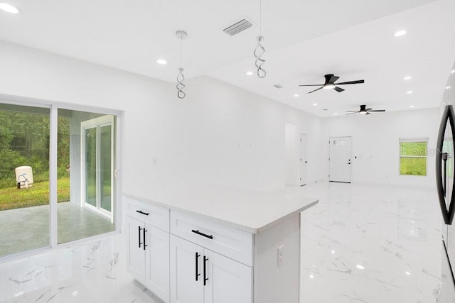 kitchen featuring pendant lighting and white cabinets