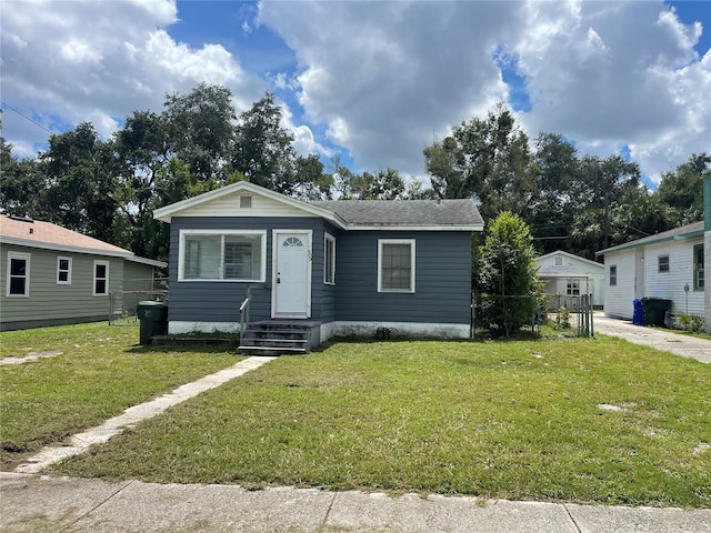 view of front of house with roof with shingles and a front lawn