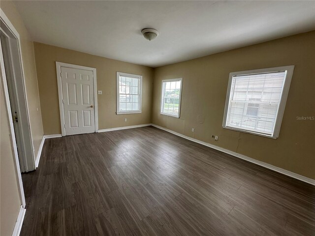 unfurnished bedroom featuring dark wood-type flooring