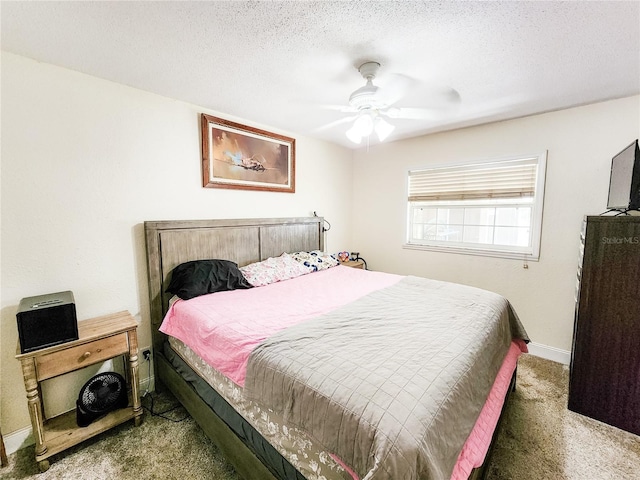 carpeted bedroom featuring a textured ceiling and ceiling fan