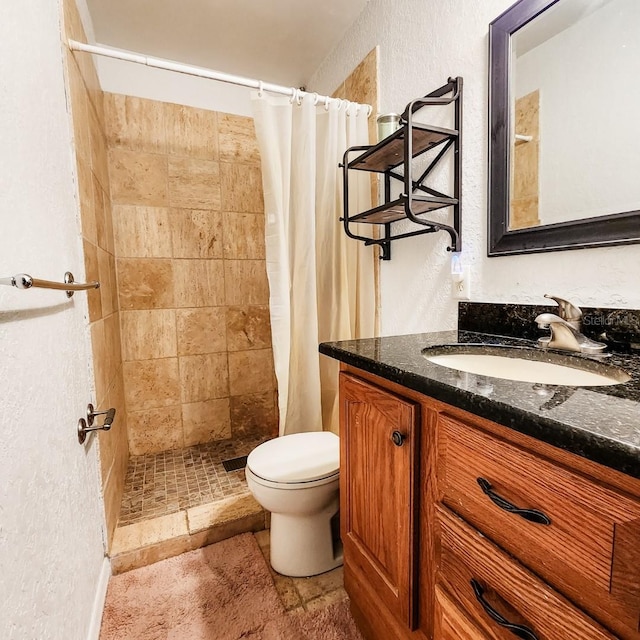 bathroom with walk in shower, vanity, and toilet