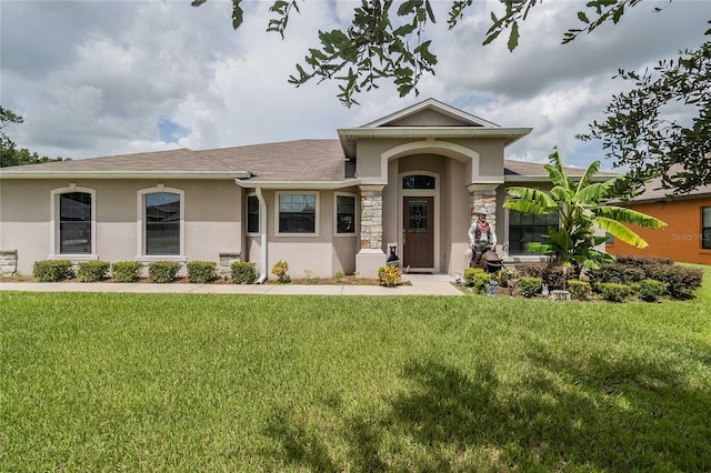 view of front of house featuring stone siding, a front lawn, and stucco siding