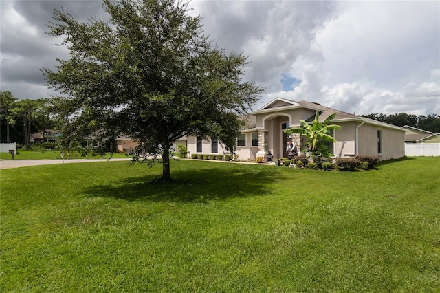 view of front of house with a front lawn and stucco siding