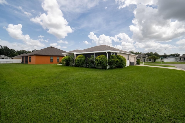 view of yard with a garage and concrete driveway