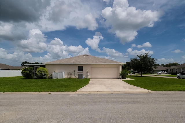 single story home with concrete driveway, central air condition unit, an attached garage, and a front lawn