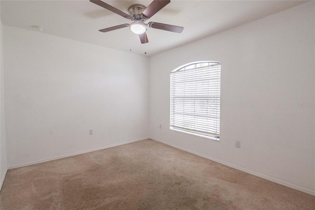 unfurnished room with ceiling fan and light carpet