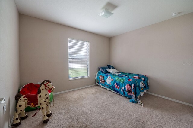 carpeted bedroom with baseboards