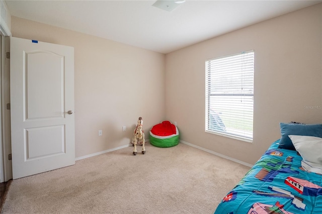 bedroom with carpet flooring and baseboards