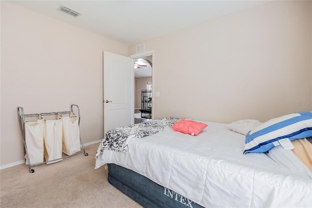 carpeted bedroom featuring visible vents and baseboards