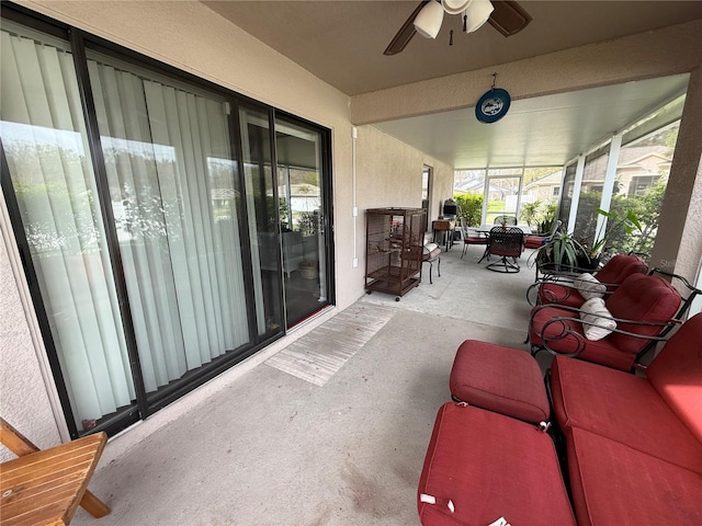 sunroom featuring ceiling fan