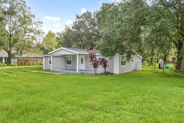 rear view of house with a lawn