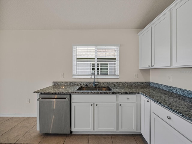 kitchen featuring light tile patterned floors, dishwasher, sink, and white cabinetry