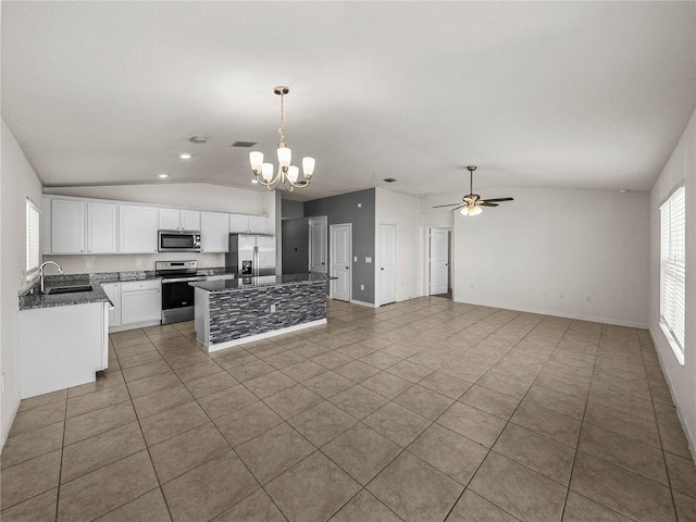 kitchen with white cabinetry, stainless steel appliances, decorative light fixtures, sink, and a center island