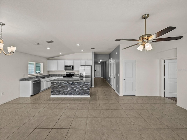 kitchen featuring ceiling fan with notable chandelier, white cabinets, appliances with stainless steel finishes, a center island, and light tile patterned flooring