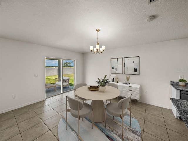 1029 Mattie Pointe Way, Auburndale, FL 33823 - tiled dining room with baseboards, a textured ceiling, and a chandelier