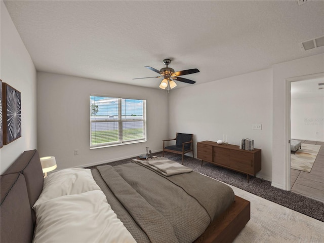 1029 Mattie Pointe Way, Auburndale, FL 33823 - bedroom with carpet flooring, a textured ceiling, baseboards, visible vents, and ceiling fan