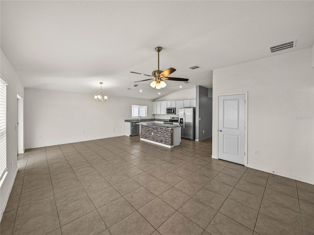 1029 Mattie Pointe Way, Auburndale, FL 33823 - unfurnished living room with ceiling fan with notable chandelier, visible vents, and lofted ceiling