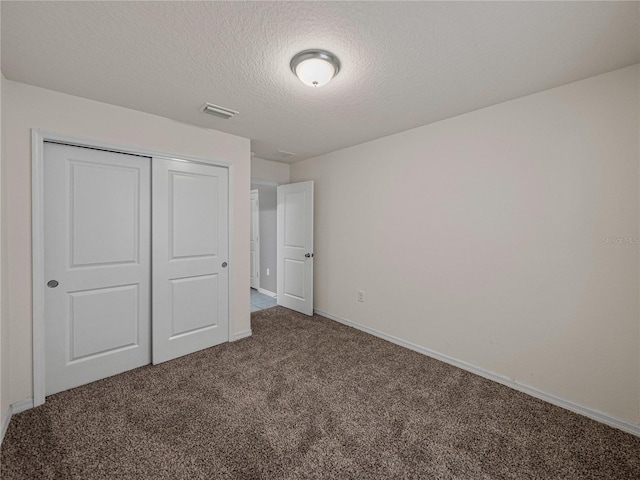 1029 Mattie Pointe Way, Auburndale, FL 33823 - unfurnished bedroom featuring carpet flooring, baseboards, a textured ceiling, visible vents, and a closet