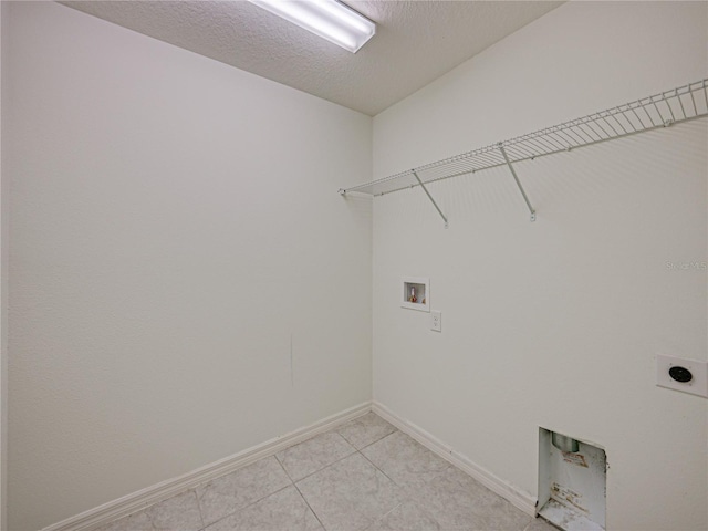 1029 Mattie Pointe Way, Auburndale, FL 33823 - laundry room featuring a textured ceiling, washer hookup, laundry area, electric dryer hookup, and light tile patterned floors