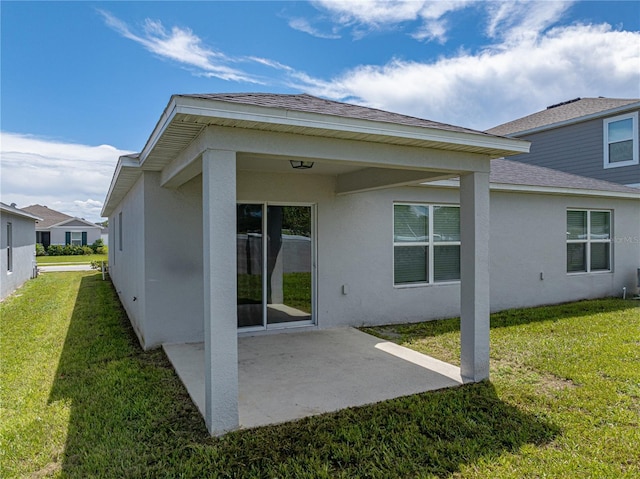 1029 Mattie Pointe Way, Auburndale, FL 33823 - back of house with a shingled roof, stucco siding, a patio area, and a yard