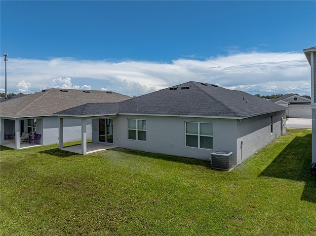 1029 Mattie Pointe Way, Auburndale, FL 33823 - rear view of house with roof with shingles, central air condition unit, stucco siding, a patio, and a yard