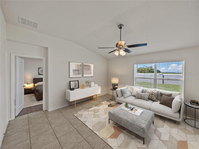 1029 Mattie Pointe Way, Auburndale, FL 33823 - living area featuring ceiling fan, light tile patterned flooring, vaulted ceiling, and visible vents