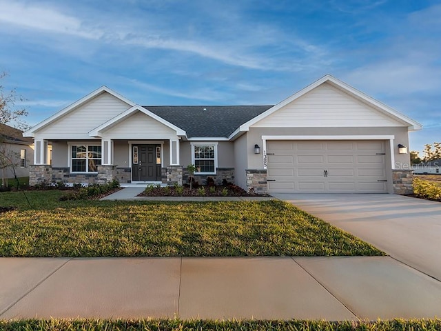 view of front of home featuring a garage and a front yard