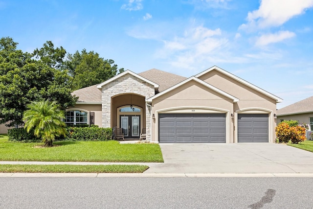 ranch-style home with a garage and a front lawn