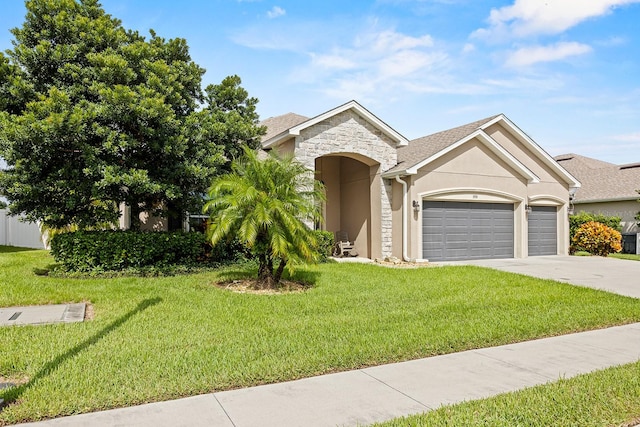 view of front of property featuring a garage and a front lawn