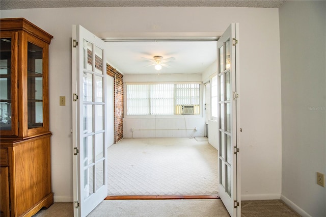 doorway to outside with cooling unit, light colored carpet, ceiling fan, and french doors