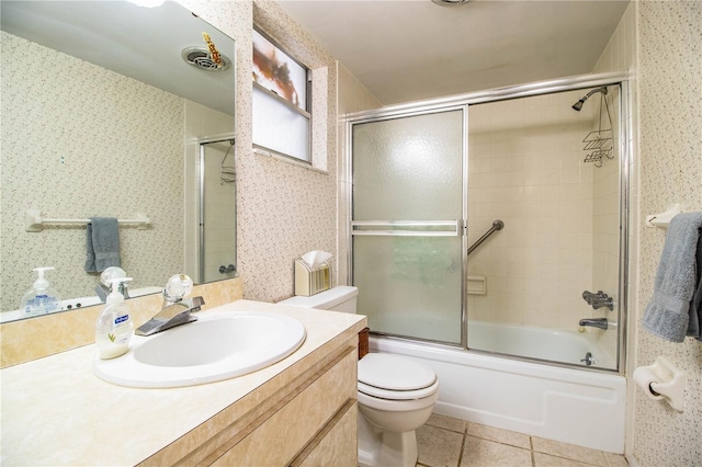 bathroom with toilet, shower / bath combination with glass door, vanity, tile patterned floors, and wallpapered walls